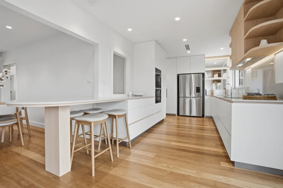 The kitchen and breakfast bar, looking towards the cooktop