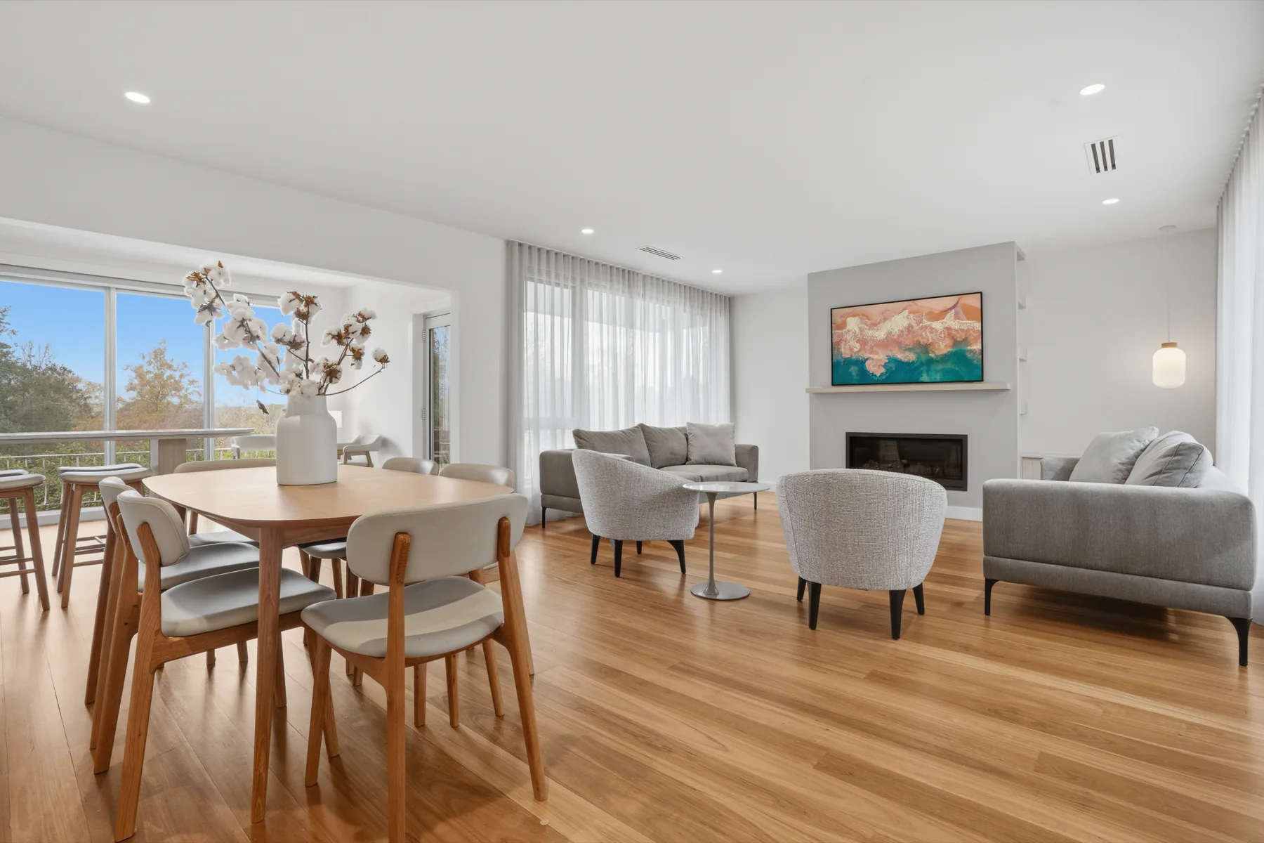 The open-plan living and dining room at The Dalton, with the deck beyond