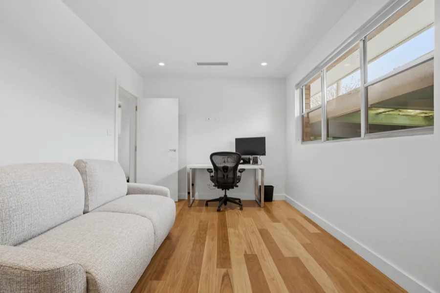The study, set up with a monitor and chair, with the sofa bed alongside